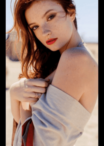 Red-haired woman with freckles, outdoor photoshoot, attractive escort model for Denver escort agency.