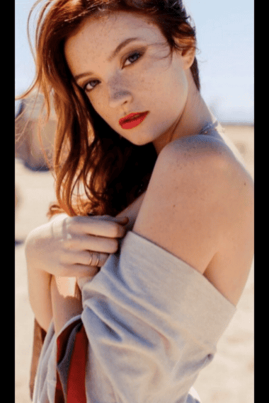 Red-haired woman with freckles, outdoor photoshoot, attractive escort model for Denver escort agency.