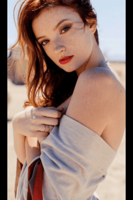 Red-haired woman with freckles, outdoor photoshoot, attractive escort model for Denver escort agency.